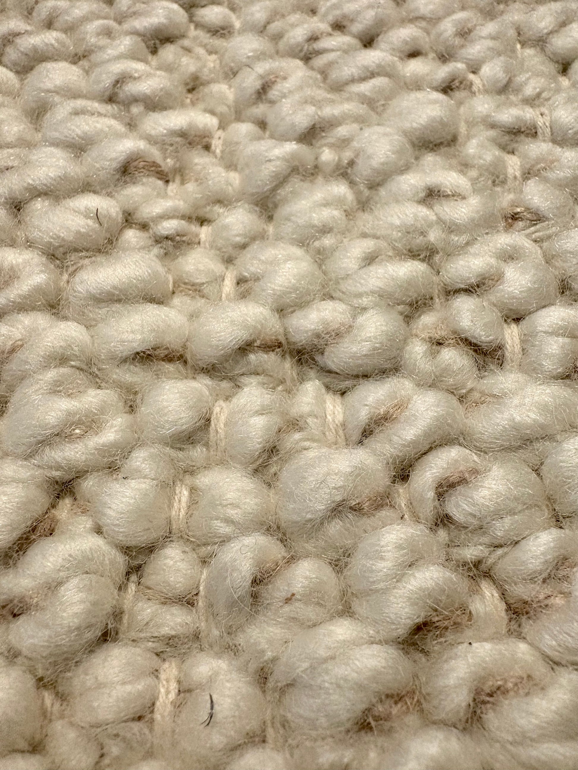 Sahara Ivory Rug – hand woven 100% wool rug in soft neutral tones with a textured finish, available in three sizes, styled for modern and coastal homes. Super Close.