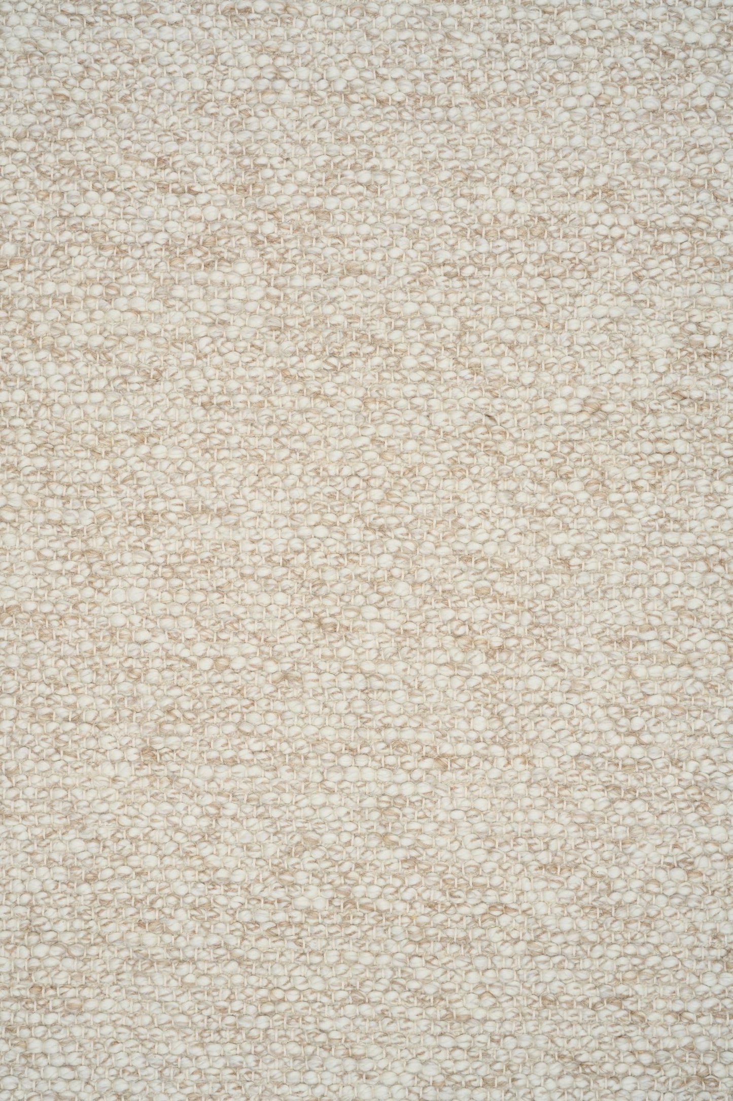 Sahara Wheat Rug – hand woven 100% wool rug in soft neutral tones with a textured finish, available in three sizes, styled for modern and coastal homes. Close.