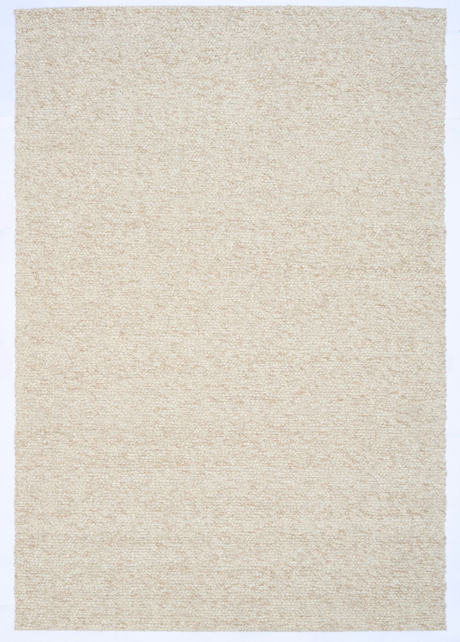 Sahara Wheat Rug – hand woven 100% wool rug in soft neutral tones with a textured finish, available in three sizes, styled for modern and coastal homes. Top.