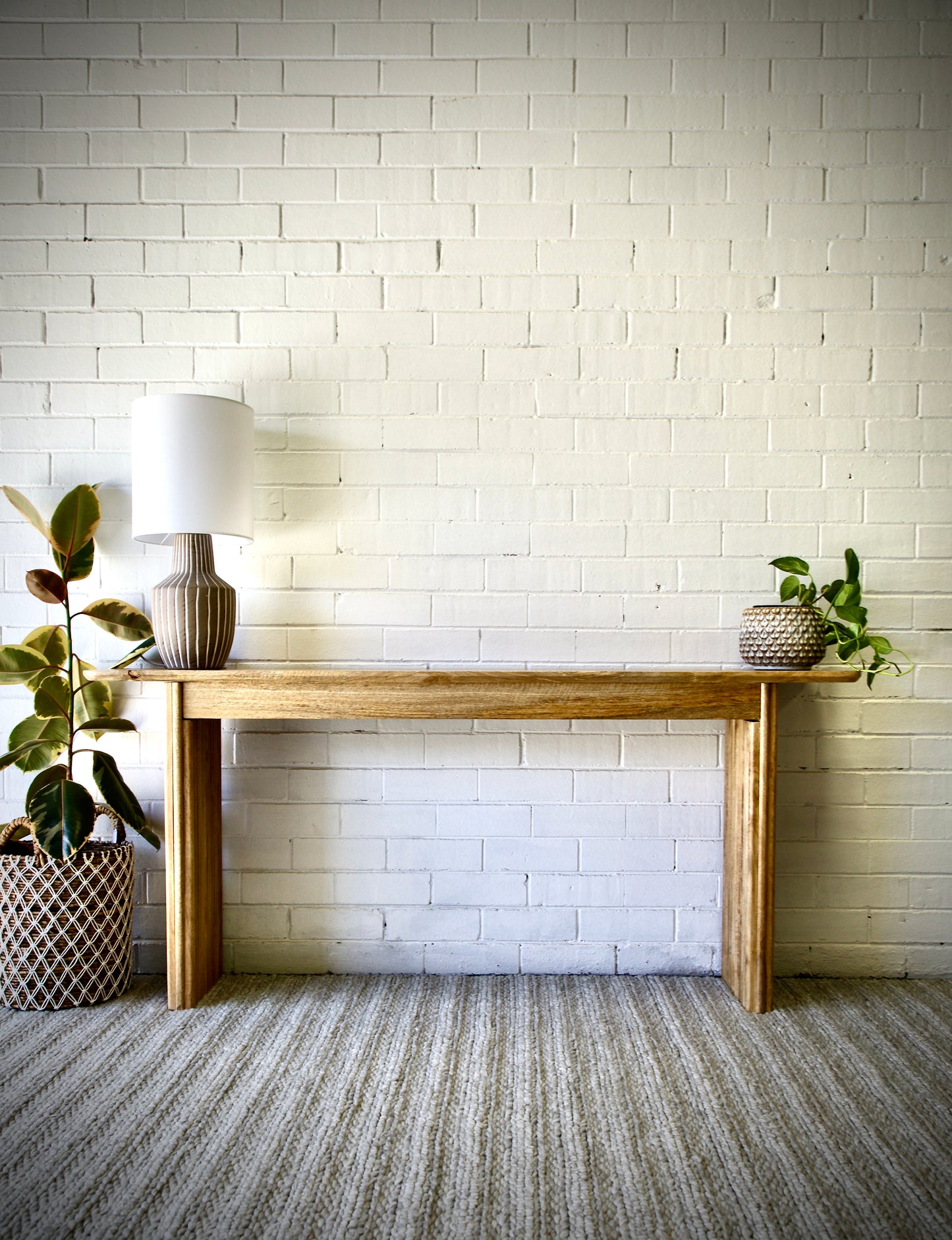 The Salzburg console, stylish and modern, this console is crafted from sustainable fruitwood and features textured legs. Colour natural. Measures 1700 length X 350 depth X 750 height. Front Styled.