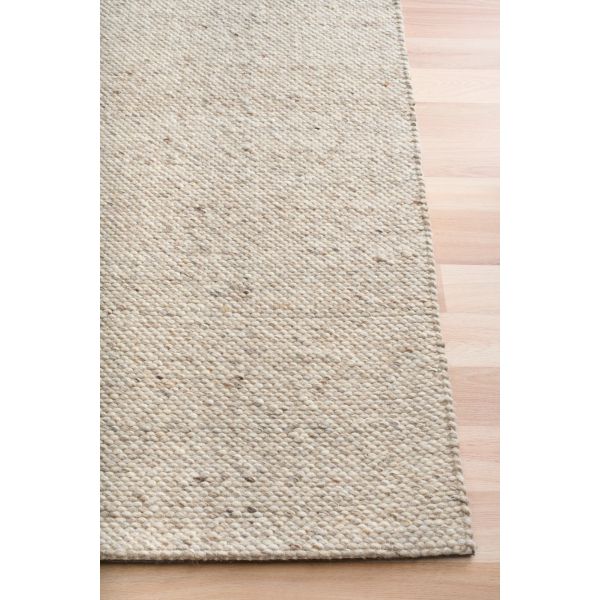 Savoy Beige is a hand-woven wool flatweave rug in an oatmeal neutral, with a fine box-weave texture. 4 size options. Corner.