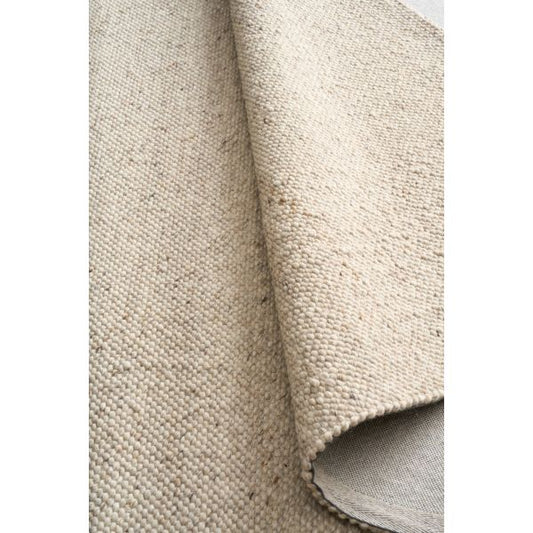 Savoy Beige is a hand-woven wool flatweave rug in an oatmeal neutral, with a fine box-weave texture. 4 size options. Roll.