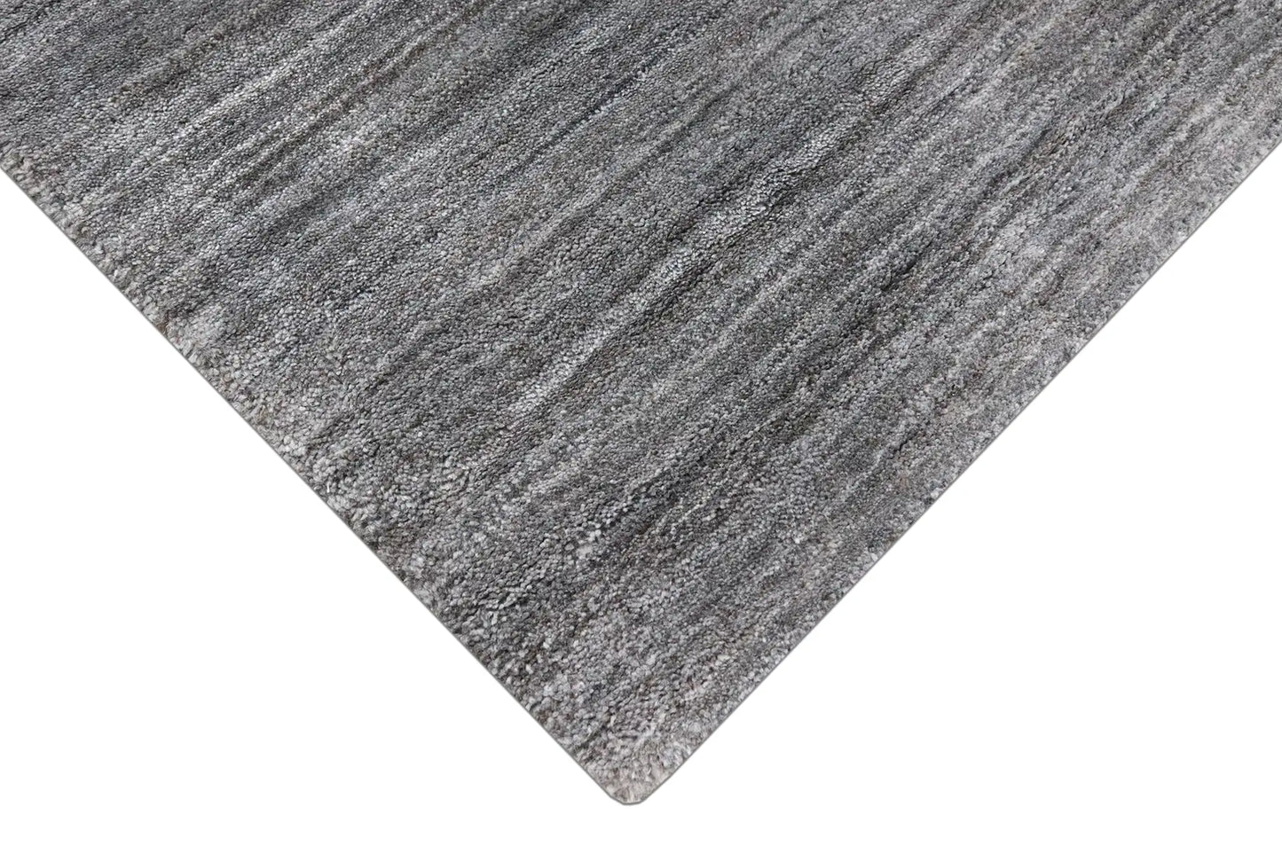 Shadow Fossil is a hand-tufted rug from a blend of wool and silky viscose with a smooth pile and a 12-14mm pile height. Colour Silver with light grey and black accents. Sizes 160 X 230, 200 X 290 and 240 X 340. Corner.