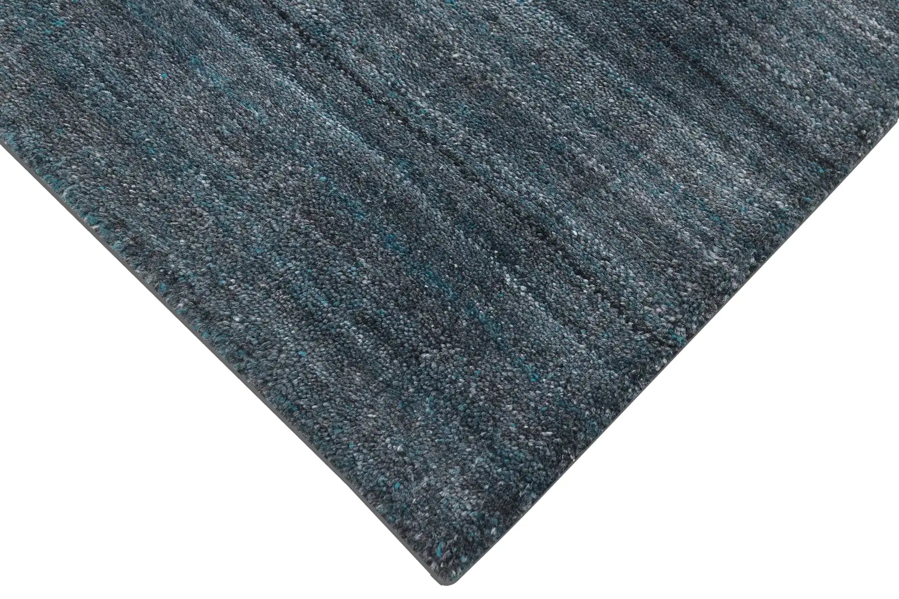 Shadow Sea Green is a hand-tufted rug from a blend of wool and silky viscose with a smooth pile and a 12-14mm pile height. Colour Dark green with grey and black accents. Sizes 160 X 230, 200 X 290 and 240 X 340. Corner.