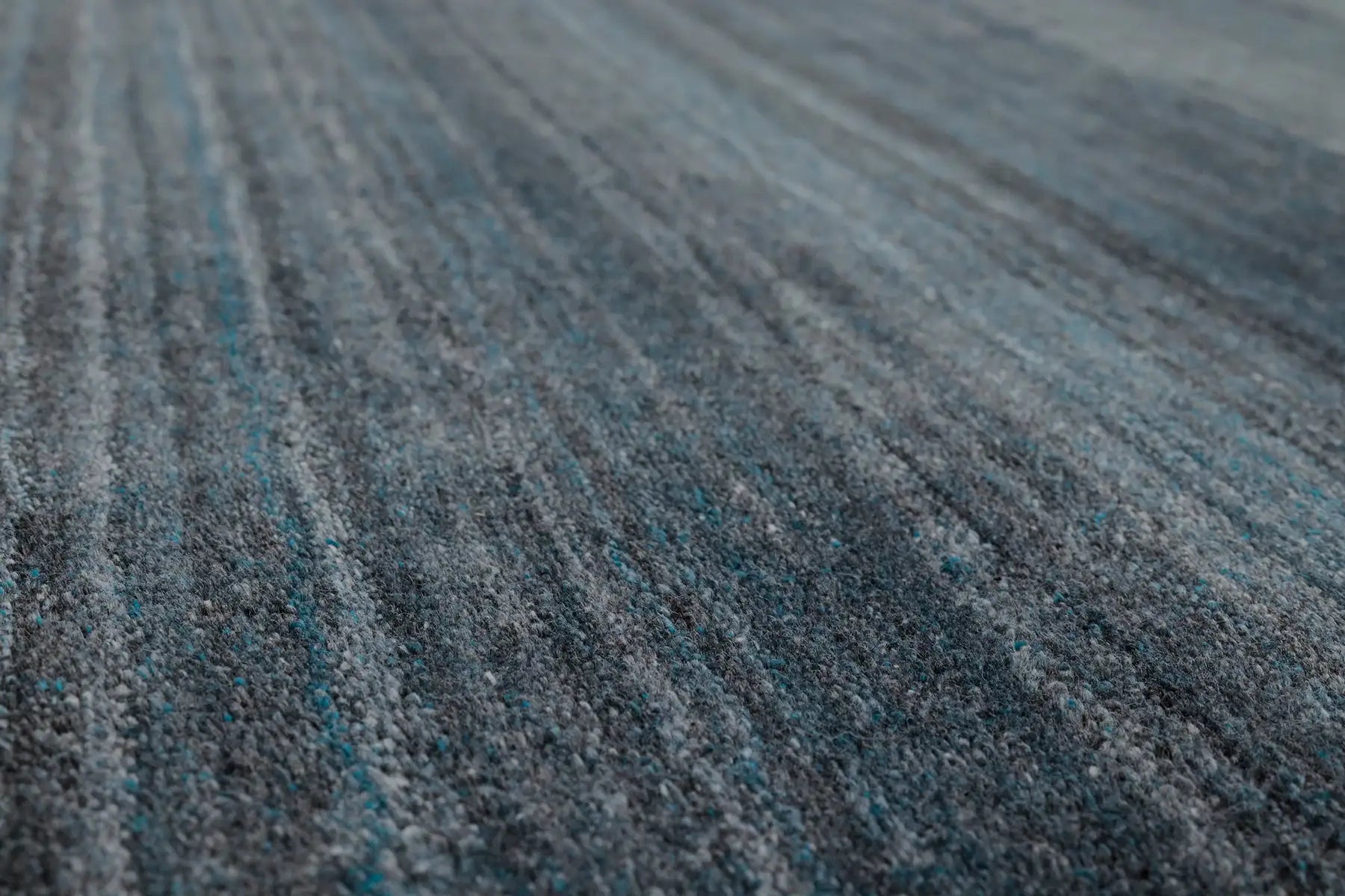 Shadow Sea Green is a hand-tufted rug from a blend of wool and silky viscose with a smooth pile and a 12-14mm pile height. Colour Dark green with grey and black accents. Sizes 160 X 230, 200 X 290 and 240 X 340. Angle.