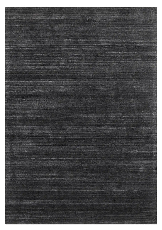 Shadow Smoke is a hand-tufted rug from a blend of wool and silky viscose with a smooth pile and a 12-14mm pile height. Colour black with light grey and silver accents. Sizes 160 X 230, 200 X 290 and 240 X 340. Full.