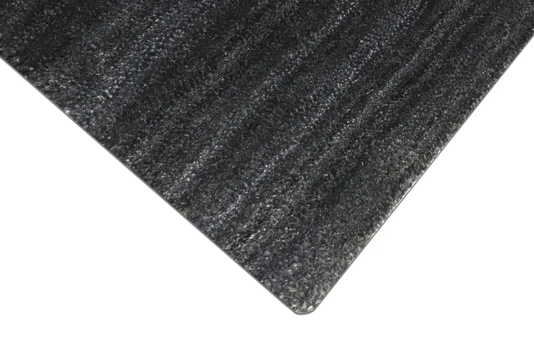 Shadow Smoke is a hand-tufted rug from a blend of wool and silky viscose with a smooth pile and a 12-14mm pile height. Colour black with light grey and silver accents. Sizes 160 X 230, 200 X 290 and 240 X 340. Corner.