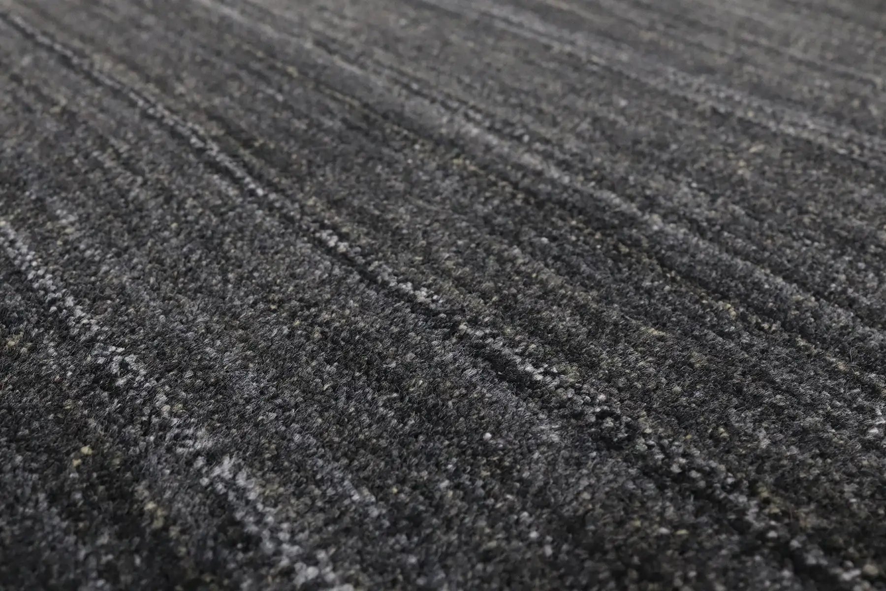 Shadow Smoke is a hand-tufted rug from a blend of wool and silky viscose with a smooth pile and a 12-14mm pile height. Colour black with light grey and silver accents. Sizes 160 X 230, 200 X 290 and 240 X 340. Angle.