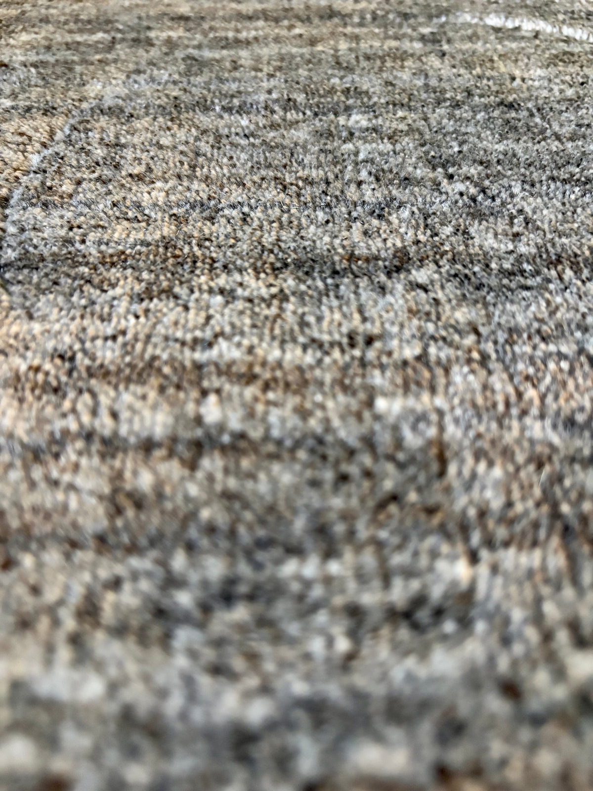 Shadow Fossil is a hand-tufted rug from a blend of wool and silky viscose with a smooth pile and a 12-14mm pile height. Colour Silver with light grey and black accents. Sizes 160 X 230, 200 X 290 and 240 X 340. Close Angle.