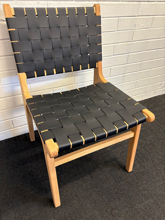 The Shawnee - Black Dining Chair, features an ash frame and black saddle leather. It has a strapped seat and back. Colours, natural frame with black leather. Measures 510 wide X 550 depth X 460 Seat height. Back height 840. Angle.