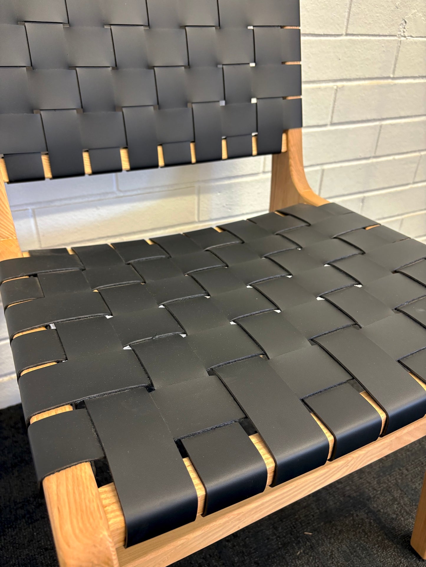 The Shawnee - Black Dining Chair, features an ash frame and black saddle leather. It has a strapped seat and back. Colours, natural frame with black leather. Measures 510 wide X 550 depth X 460 Seat height. Back height 840. Close.