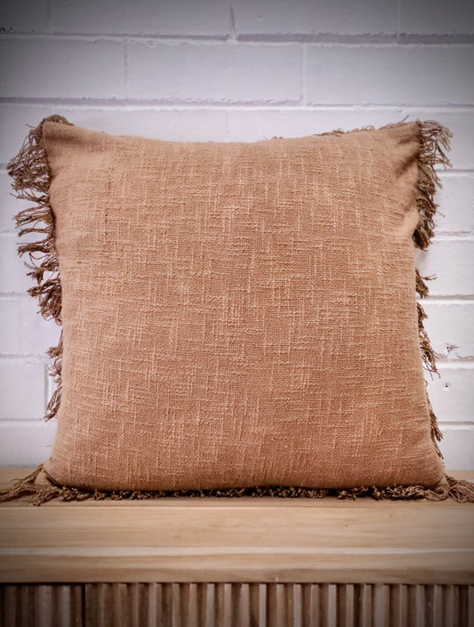 The Sun Baked, orange, throw cushion is made by skilled artisan weavers in India. Crafted from cotton slub, it features a luxurious textured feel. Boasts tasseled edges. Colour burnt orange. Sizes, 50 X 50 and 60 X 60. Front Styled.