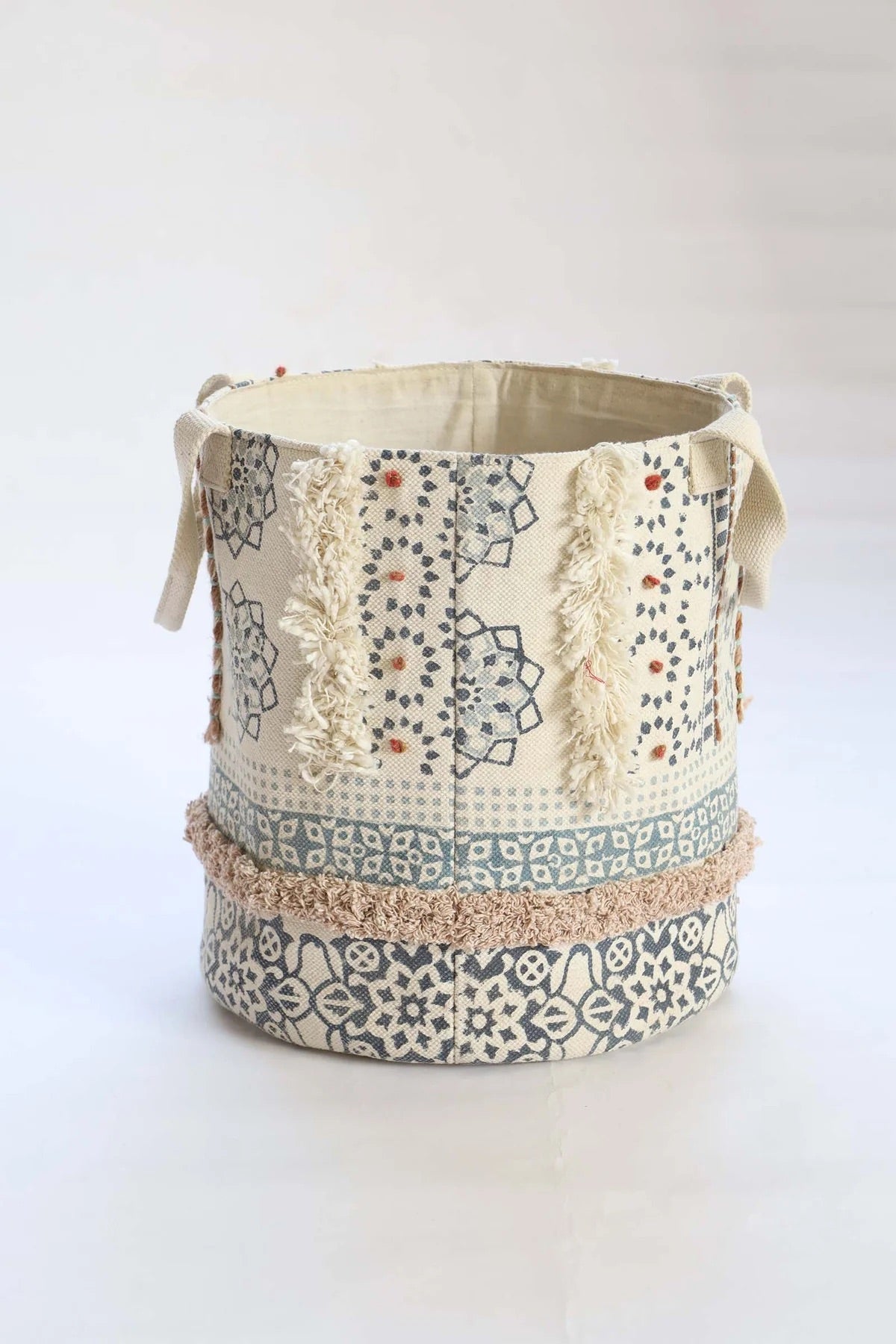 The Super Sonic basket is crafted by skilled artisans in India. Crafted from cotton, it features bold block print motifs and textured bits of cotton. With 2 handles it's easy to pick up and move around. Colours, cream, grey, dark grey and browns. Size 400 height X 350 diameter. Back Plain.