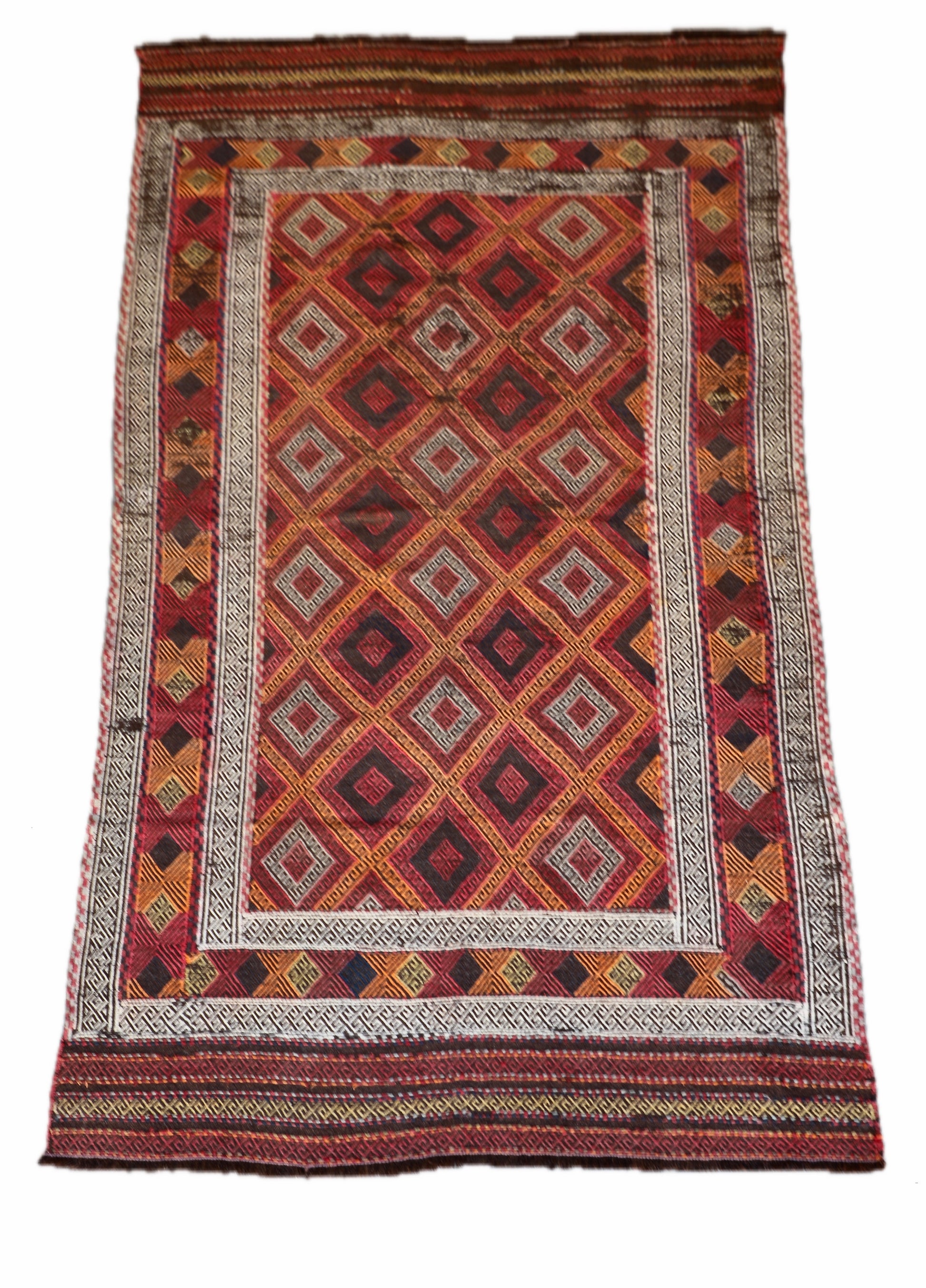The Afghan Hand Woven Wool Suzani Kilim - 151 X 286. Hand woven by skilled afghan weavers, and featuring traditional bold geometric designs. Colours, oranges, reds, browns and creams. Measures 151 wide X 286 long. Cover.