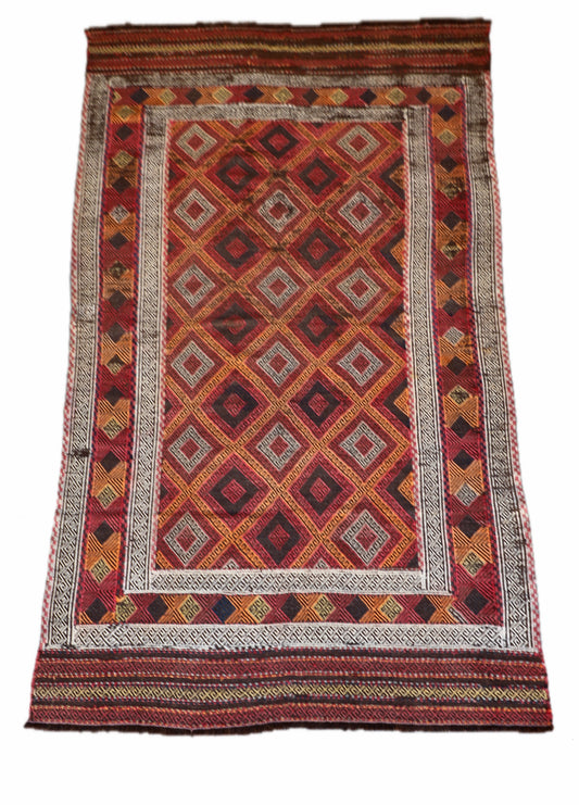 The Afghan Hand Woven Wool Suzani Kilim - 151 X 286. Hand woven by skilled afghan weavers, and featuring traditional bold geometric designs. Colours, oranges, reds, browns and creams. Measures 151 wide X 286 long. Cover.