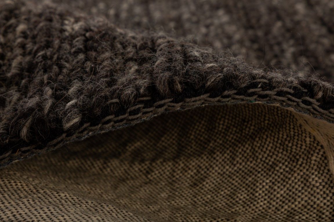 Svend Charcoal is a contemporary hand woven braided pile wool rug.  Colour Charcoal/black. Sizes 155 X 225, 200 X 290, 240 X 320 and 300 X 400. Side.
