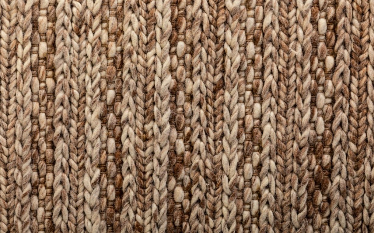 Svend Taupe is a contemporary hand woven braided pile wool rug.  Colours Taupe Brown with Beige accents. Sizes 155 X 225, 200 X 290, 240 X 320 and 300 X 400. Close.