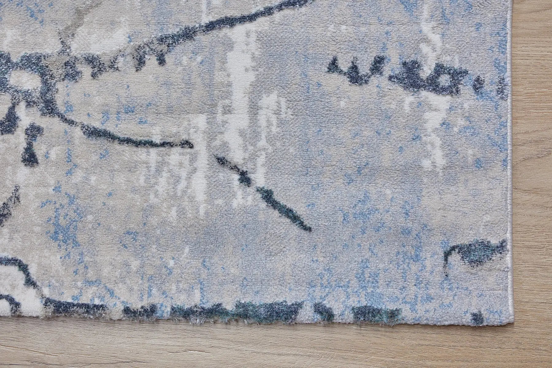 Swiss Silver is a machine-made polyester rug with an abstract modern/contemporary design. It boasts a 7-9mm pile height. Colours silver with grey and blue accents. Sizes 160 X 230, 200 X 290, 240 X 340 and 300 X 400. Corner.