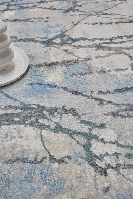Swiss Silver is a machine-made polyester rug with an abstract modern/contemporary design. It boasts a 7-9mm pile height. Colours silver with grey and blue accents. Sizes 160 X 230, 200 X 290, 240 X 340 and 300 X 400. Life.