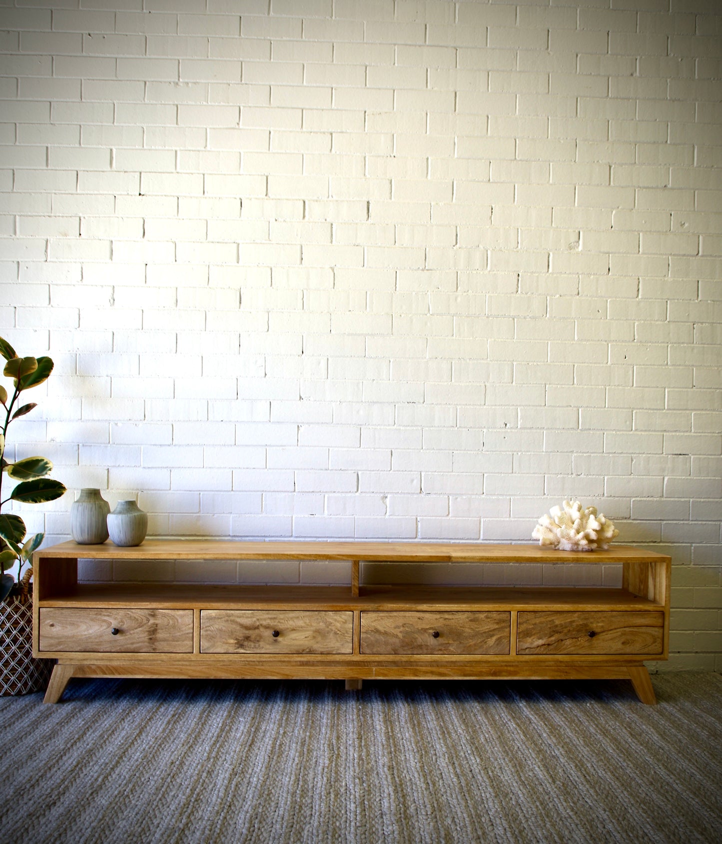 The Taylor 1800 Entertainment Unit features a modern style. It is constructed of sustainable fruitwood. The 4 drawers are on wooden runners and has two open shelves. Colour natural. Measures 1800 length X 400 depth X 500 height. Front Styled.