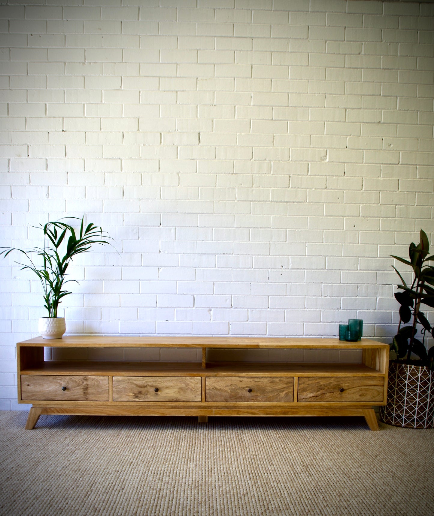 The Taylor 2100 Entertainment Unit features a modern style. It is constructed of sustainable fruitwood. The 4 drawers are on wooden runners and has two open shelves. Colour natural. Measures 2100 length X 400 depth X 500 height. Front Styled.