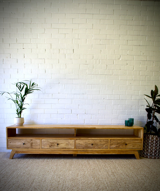 The Taylor 2100 Entertainment Unit features a modern style. It is constructed of sustainable fruitwood. The 4 drawers are on wooden runners and has two open shelves. Colour natural. Measures 2100 length X 400 depth X 500 height. Front Styled.