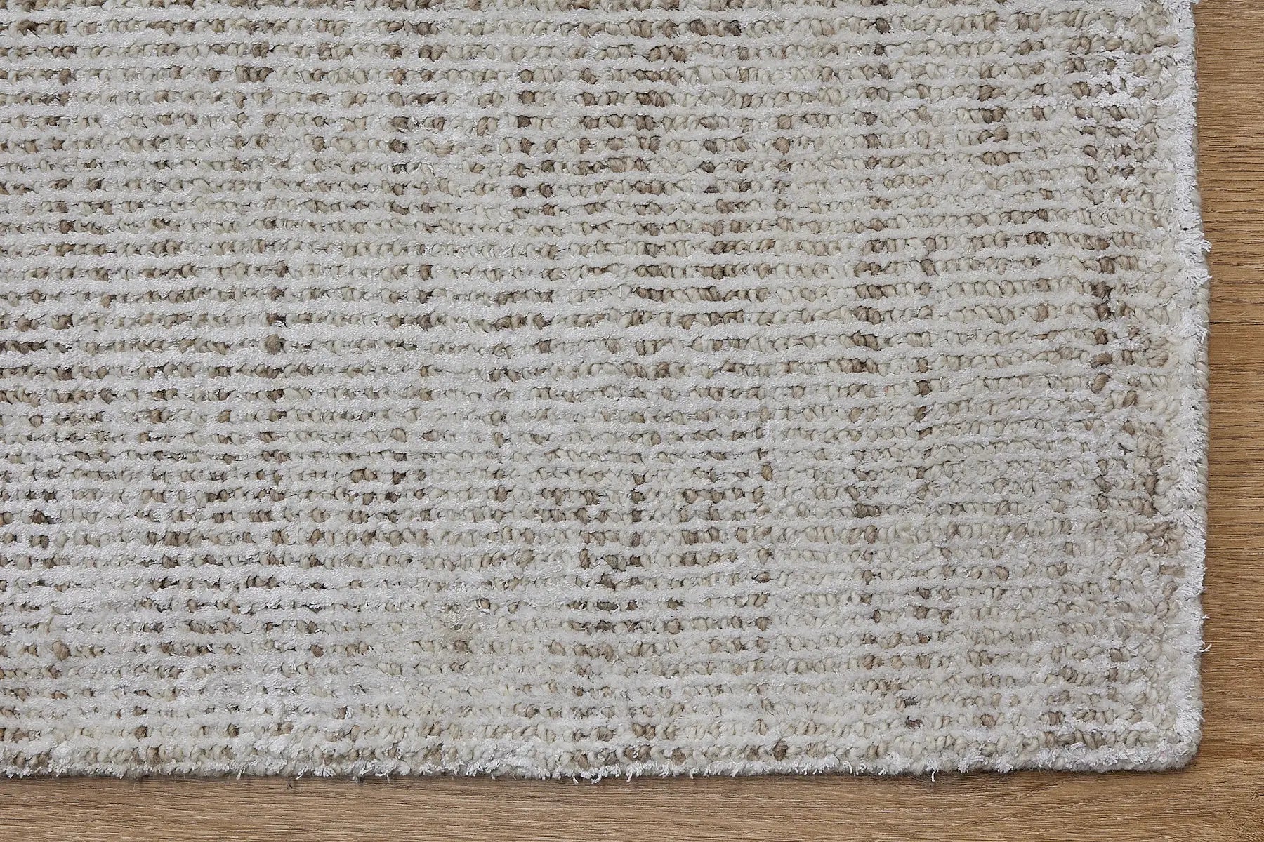 Toro Beige is a hand-loomed, hand-knotted rug with a contemporary multi-fleck design. Wool and silky viscose are blended to create a soft feel with its 10-12mm pile height. Colour light beige with brown accents. Sizes 160 X 230, 200 X 290 and 240 X 340. Corner.