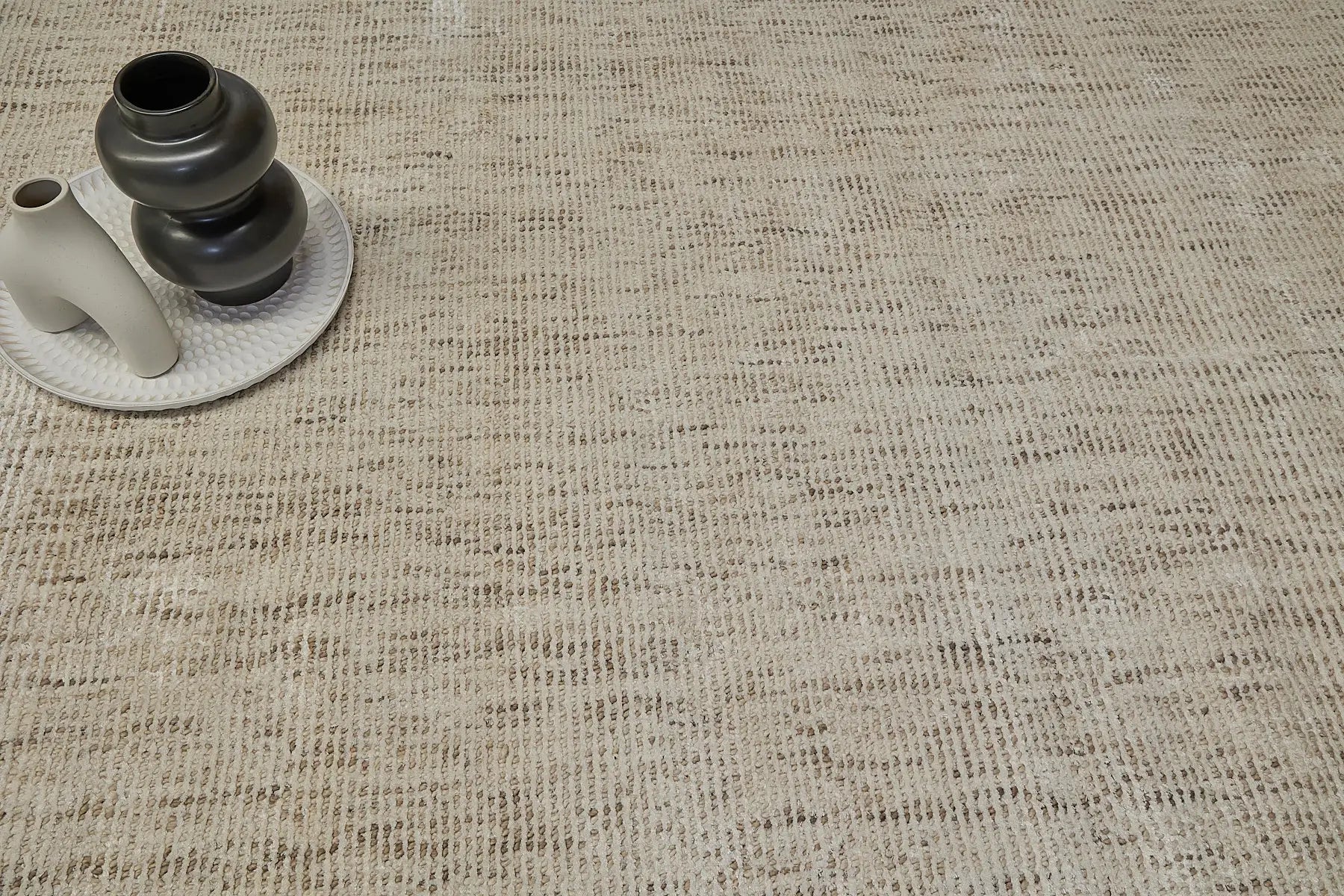 Toro Beige is a hand-loomed, hand-knotted rug with a contemporary multi-fleck design. Wool and silky viscose are blended to create a soft feel with its 10-12mm pile height. Colour light beige with brown accents. Sizes 160 X 230, 200 X 290 and 240 X 340. Life.