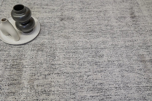 Toro Silver is a hand-loomed, hand-knotted rug with a contemporary multi-fleck design. Wool and silky viscose are blended to create a soft feel with its 10-12mm pile height. Colour Silver with dark grey accents. Sizes 160 X 230, 200 X 290 and 240 X 340. Life.