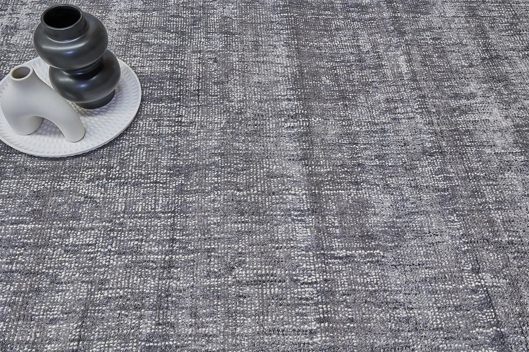 Toro Slate is a hand-loomed, hand-knotted rug with a contemporary multi-fleck design. Wool and silky viscose are blended to create a soft feel with its 10-12mm pile height. Colour Dark Grey with silver accents. Sizes 160 X 230, 200 X 290, 240 X 340 and 300 X 400. Life.