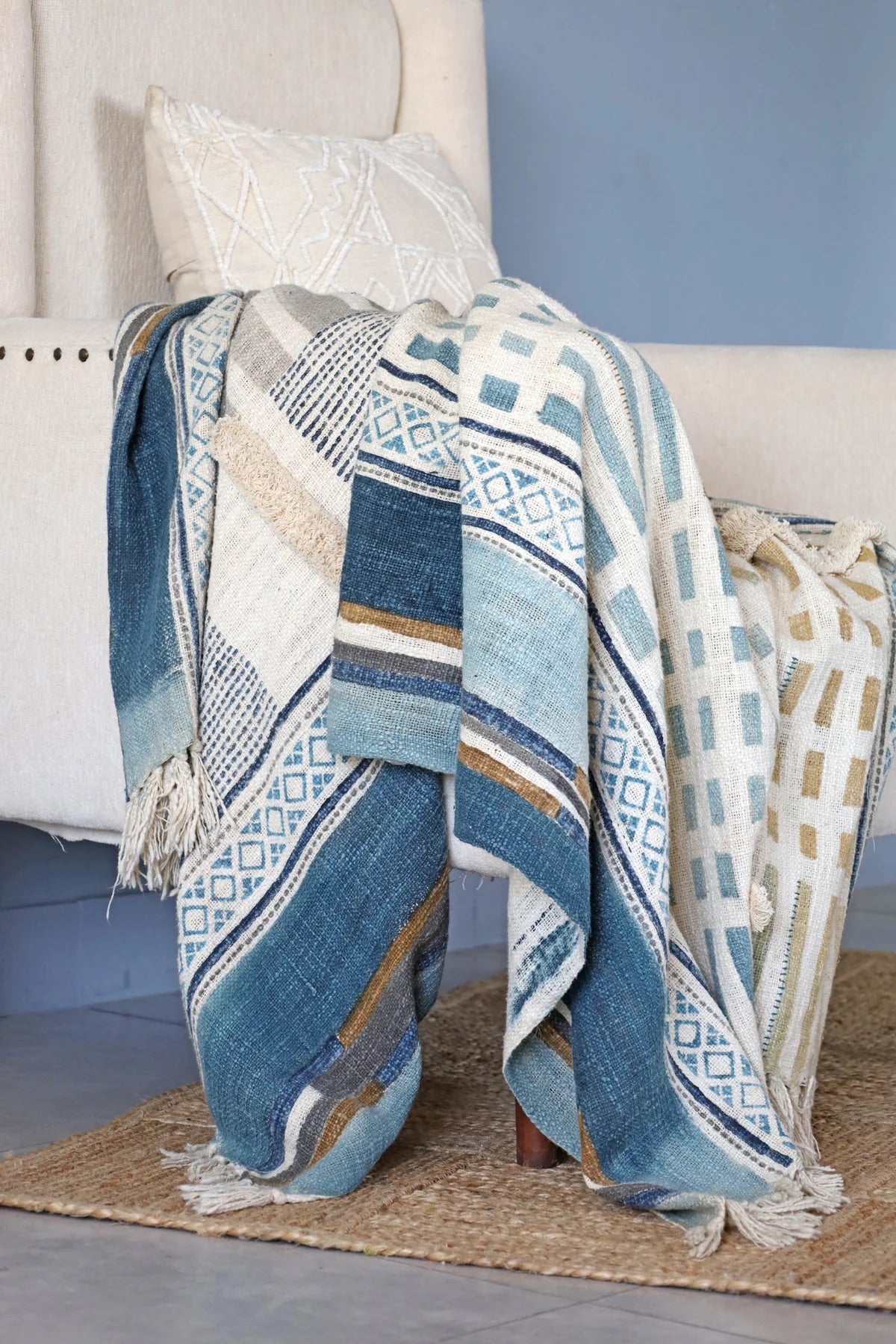 The Urbanic handcrafted throw blanket, adorned with a block print and playful tassels. Crafted from cotton slub from skilled artisans in India. It features a smooth textured feel. Indulge in the latest trend of Geometric Art with stunning shades of blue. Colours, blues, whites, beiges and greys. Size 130 X 170. Styled.