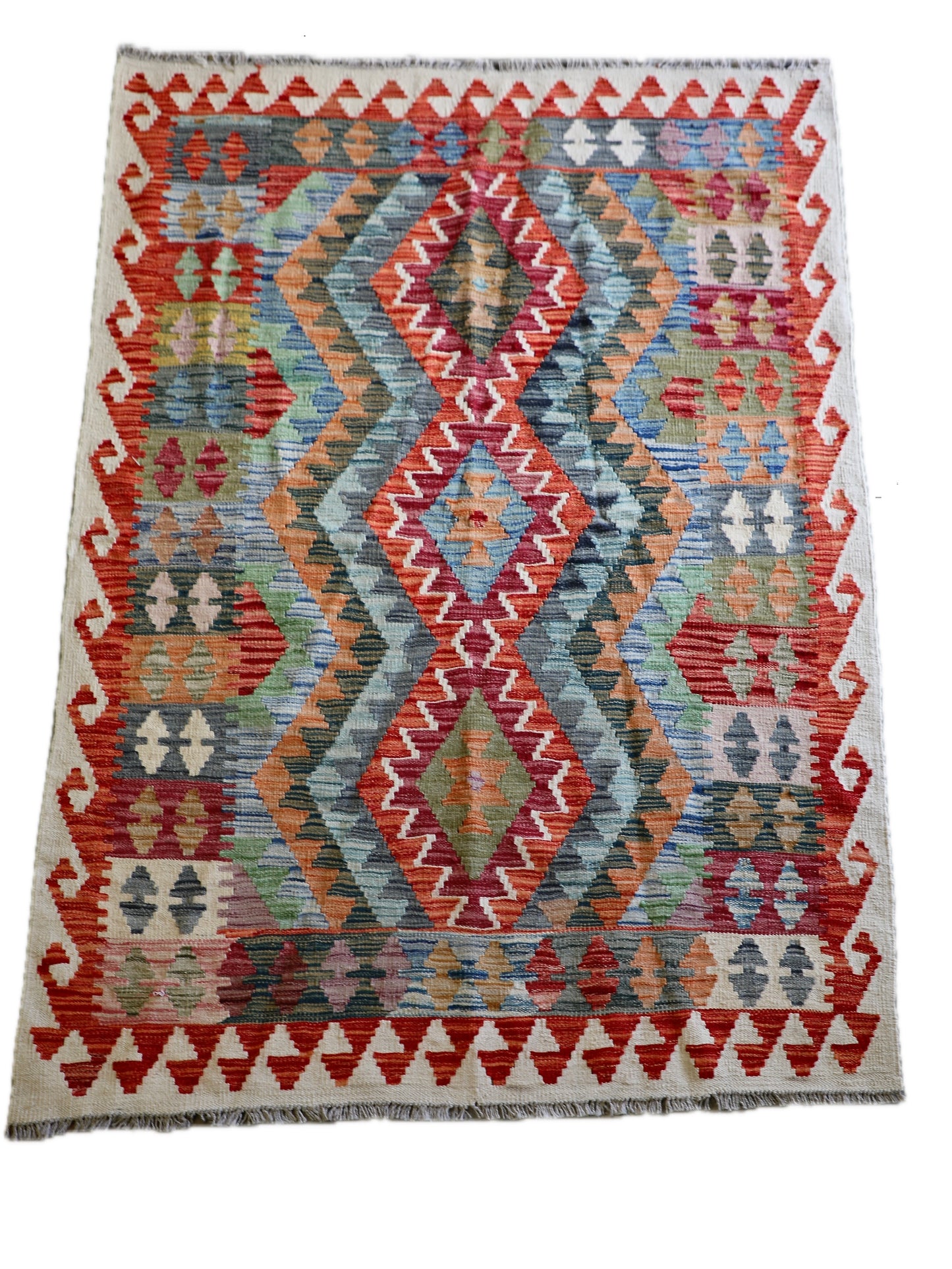 The Afghan Hand Woven Khyber Kilim - 124 X 178. Crafted using traditional vegetable dyed wool, and featuring traditional geometric designs. Colours, creams, oranges, greens and blues. Size 124 X 178. Cover.