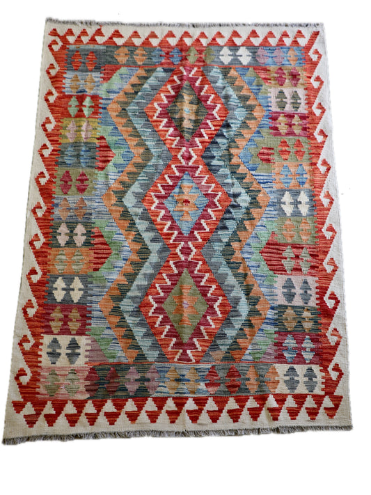 The Afghan Hand Woven Khyber Kilim - 124 X 178. Crafted using traditional vegetable dyed wool, and featuring traditional geometric designs. Colours, creams, oranges, greens and blues. Size 124 X 178. Cover.