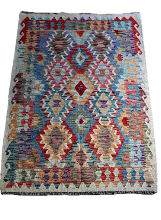 The Afghan Khyber Kilim - 126 X 178.  Crafted using traditional vegetable dyed wool, and featuring traditional geometric designs. Colours, Beige, blue, red, yellow brown. Size 126 X 178. Cover.
