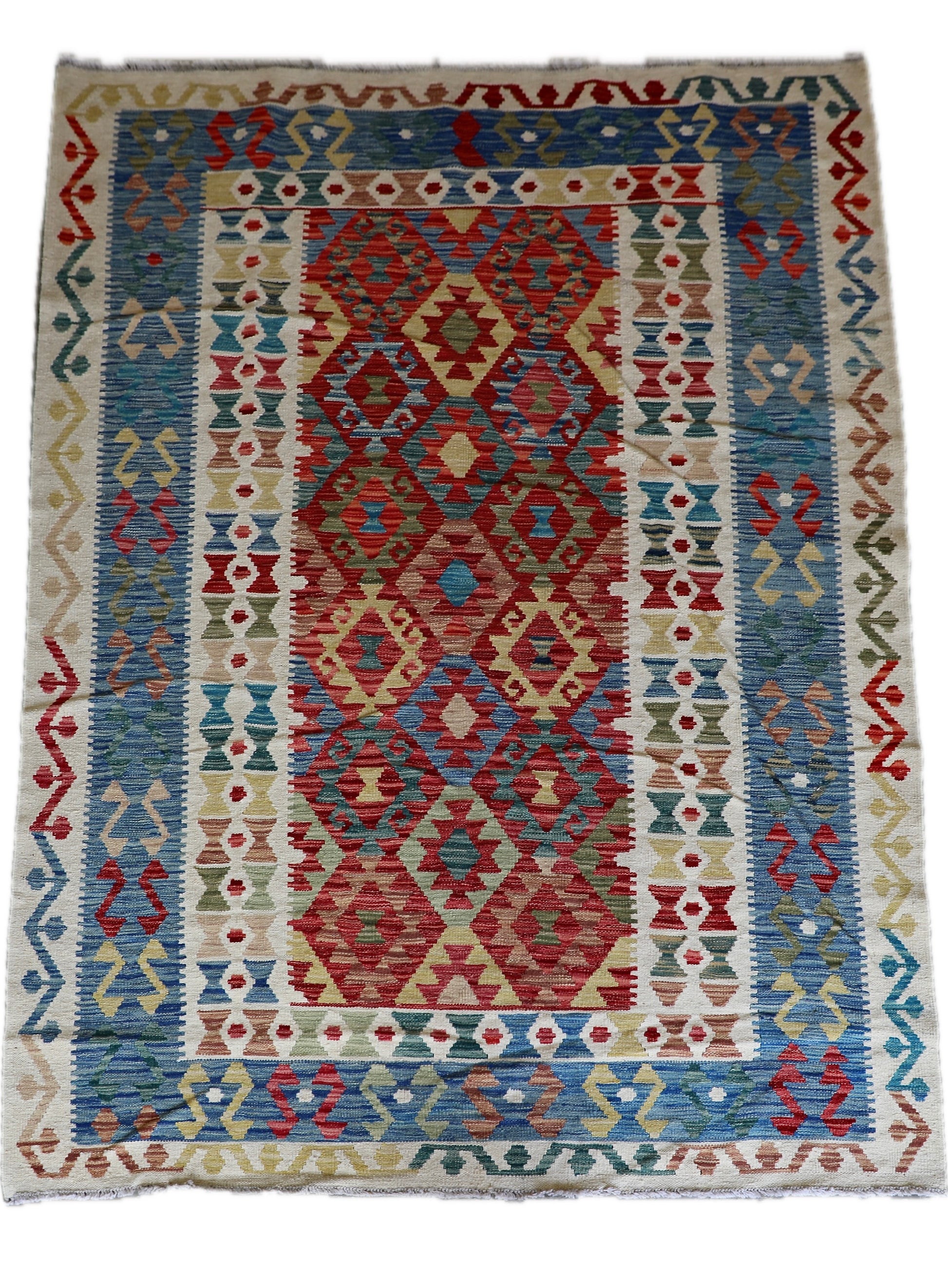 The Afghan Hand Woven Khyber Kilim - 180 X 248. Crafted using traditional vegetable dyed wool, and featuring traditional geometric designs. Colours, cream, blues, greens, reds, oranges. Size 180 X 248. Cover.