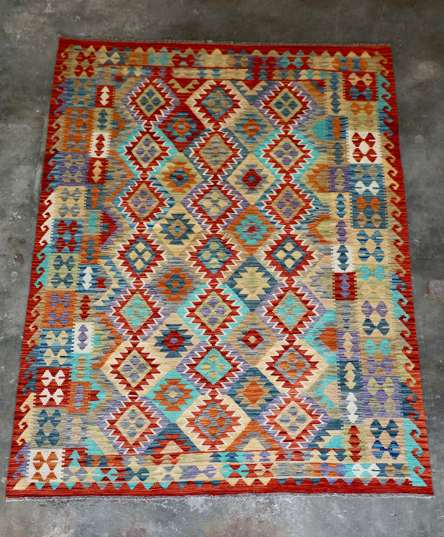 The Afghan Hand Woven Khyber Kilim - 202 X 286. Crafted using traditional vegetable dyed wool, and featuring traditional geometric designs. Colours, reds, blues, greens, yellows and oranges. Size 202 X 286. Front.