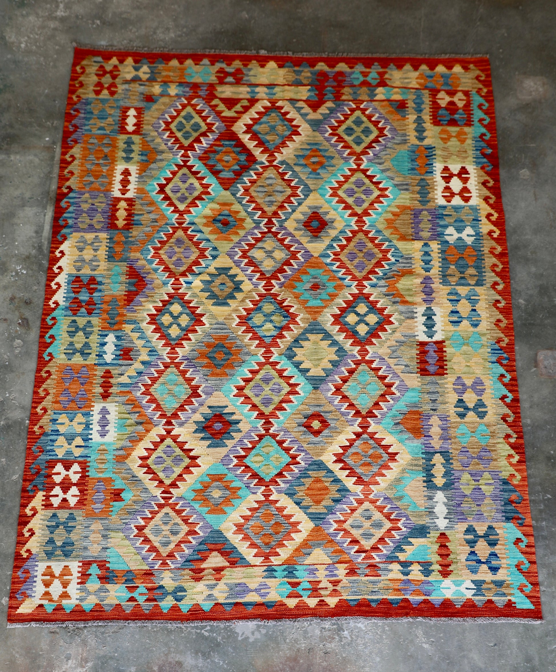 The Afghan Hand Woven Khyber Kilim - 202 X 286. Crafted using traditional vegetable dyed wool, and featuring traditional geometric designs. Colours, reds, blues, greens, yellows and oranges. Size 202 X 286. Front.
