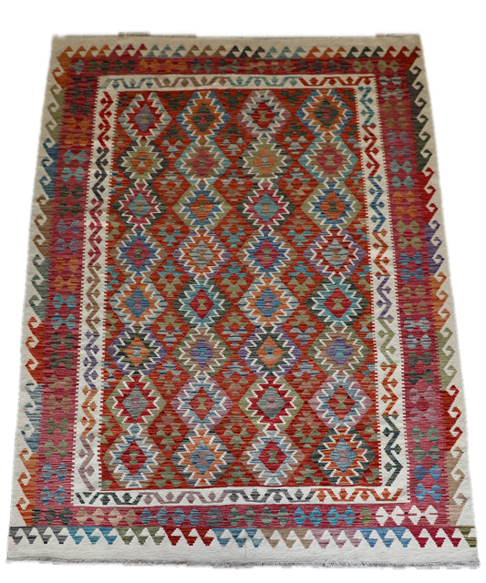 The Afghan Hand Woven Wool Khyber Kilim - 206 X 296.  Crafted using traditional vegetable dyed wool, and featuring traditional geometric designs. Colours, cream, reds, oranges, teals, blues and beiges. Size 206 X 296. Cover.