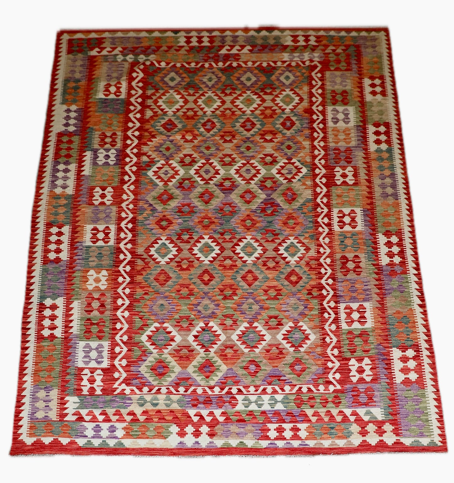 The Afghan Hand Woven Khyber Kilim - 252 X 345. Crafted using traditional vegetable dyed wool, and featuring traditional geometric designs. Colours, Oranges, reds, creams, teals. Size 252 X 345. Cover.