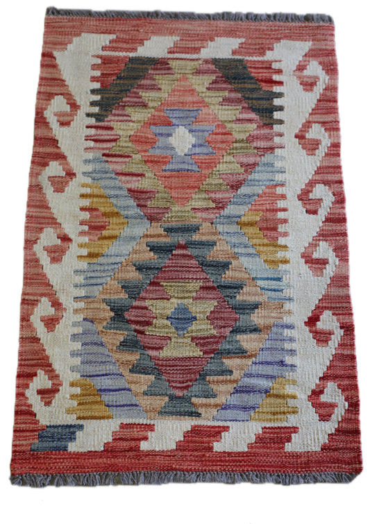 The Afghan Hand Woven Khyber Kilim - 62 X 92. Crafted using traditional vegetable dyed wool, and featuring traditional geometric designs. Colours, oranges, creams, light blues, dark greens. Size 62 X 92. Cover.