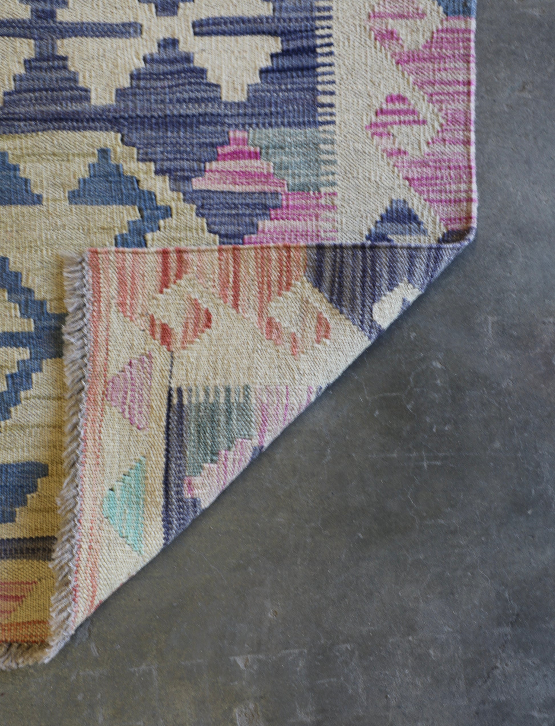 The Afghan Hand Woven Khyber Kilim 63 X 89. Crafted using traditional vegetable dyed wool, and featuring traditional geometric designs. Colours, beiges, light greys, blues. Size 63 X 89. Fold.