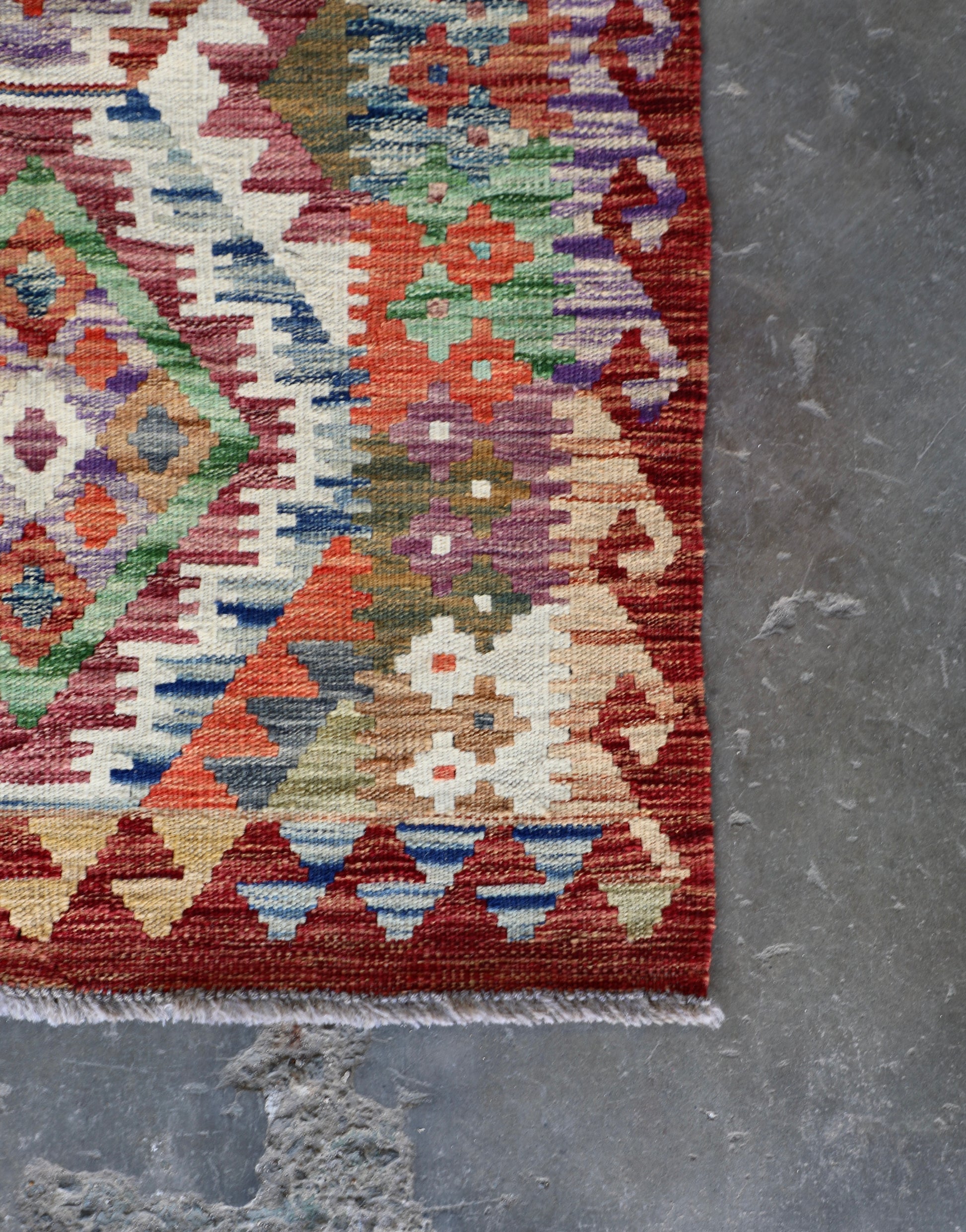 The Afghan Hand Woven Khyber Kilim Runner - 80 X 287. Crafted using traditional vegetable dyed wool, and featuring traditional geometric designs.  Colours, Oranges, reds, yellow, teals and creams. Measures 80 wide X 287 long. Corner.
