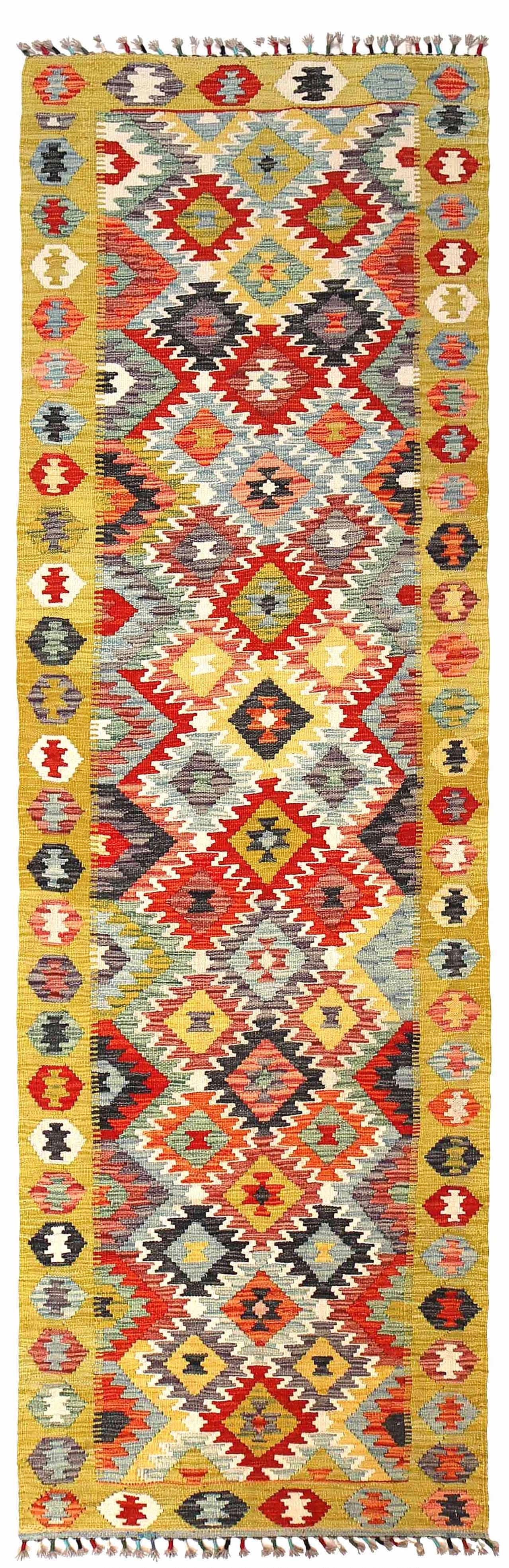 The Afghan Hand Woven Khyber Kilim Runner - 86 X 290.  Crafted using traditional vegetable dyed wool, and featuring traditional geometric designs. Colours, yellows, creams, beiges, oranges, blues and more. Measures 86 wide X 290 long. Cover.