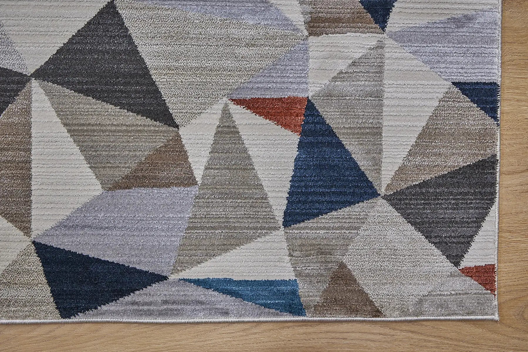 Vienna Triangle is a polyester machine made geometric modern/contemporary rug.  It features a 7-9mm Pile height for a soft luxurious feel.  Colours white, silver, with blue and orange beige accents. Sizes 160 X 230, 200 X 290, 240 X 340 and 300 X 400. Corner.