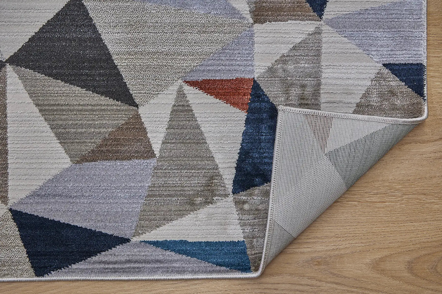 Vienna Triangle is a polyester machine made geometric modern/contemporary rug.  It features a 7-9mm Pile height for a soft luxurious feel.  Colours white, silver, with blue and orange beige accents. Sizes 160 X 230, 200 X 290, 240 X 340 and 300 X 400. Fold.