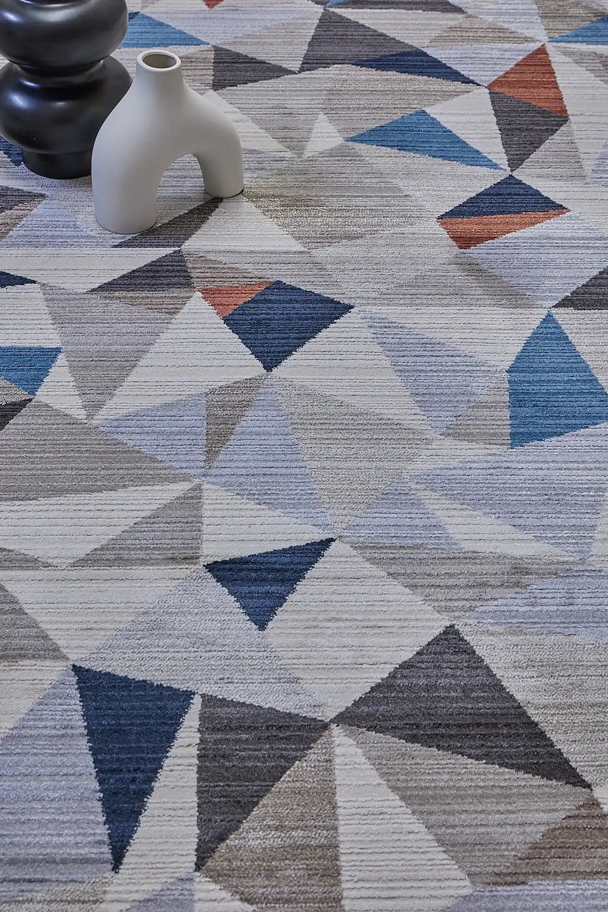 Vienna Triangle is a polyester machine made geometric modern/contemporary rug.  It features a 7-9mm Pile height for a soft luxurious feel.  Colours white, silver, with blue and orange beige accents. Sizes 160 X 230, 200 X 290, 240 X 340 and 300 X 400. Life.