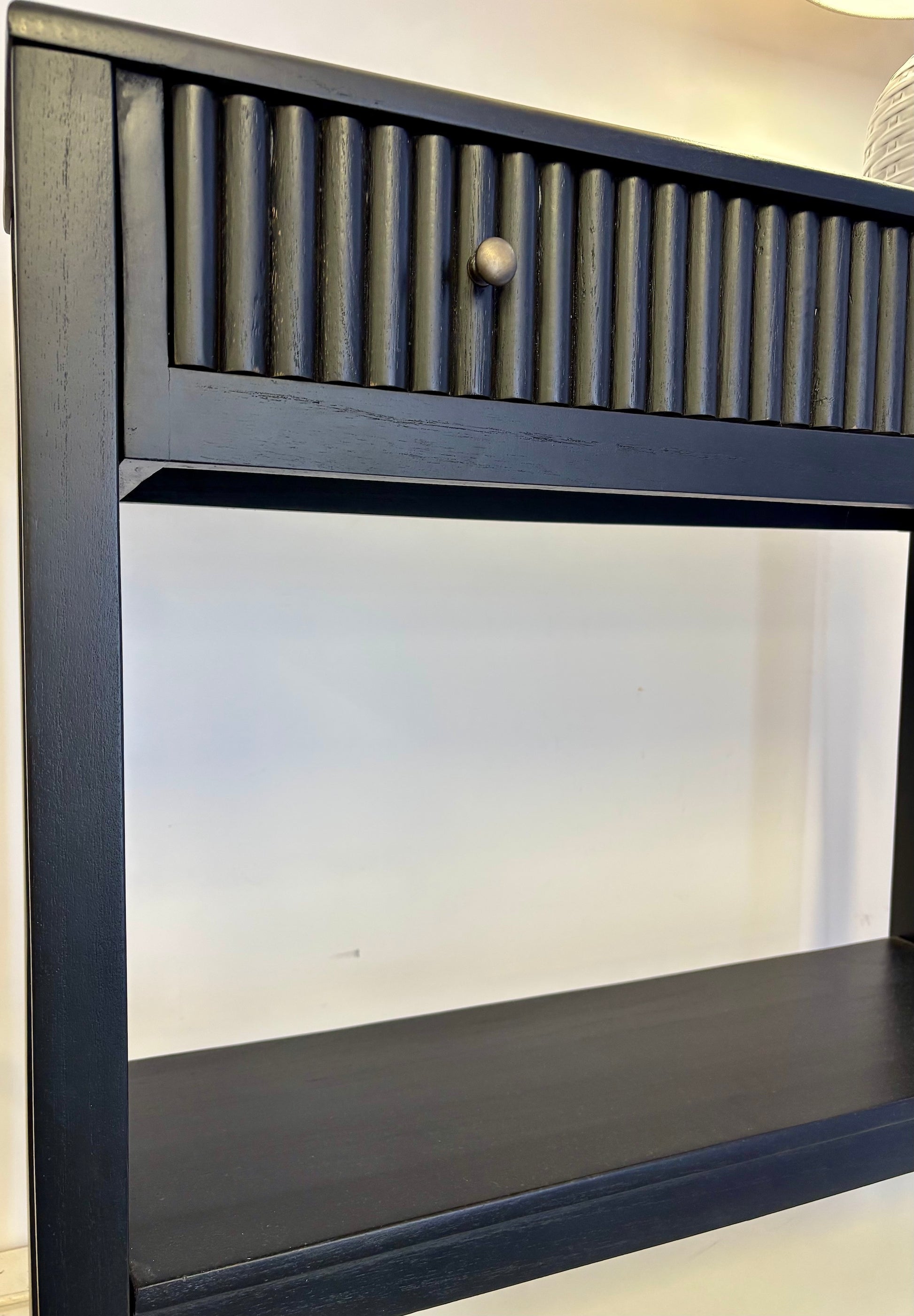 The Vienna - 1 Drawer Black Console brings a contemporary feel with its sleek design and textured drawer face. Built with sustainable white cedar its 1-drawer sits on wooden runners. Colour black. Measures 800 length X 250 depth X 750 height. Angle.