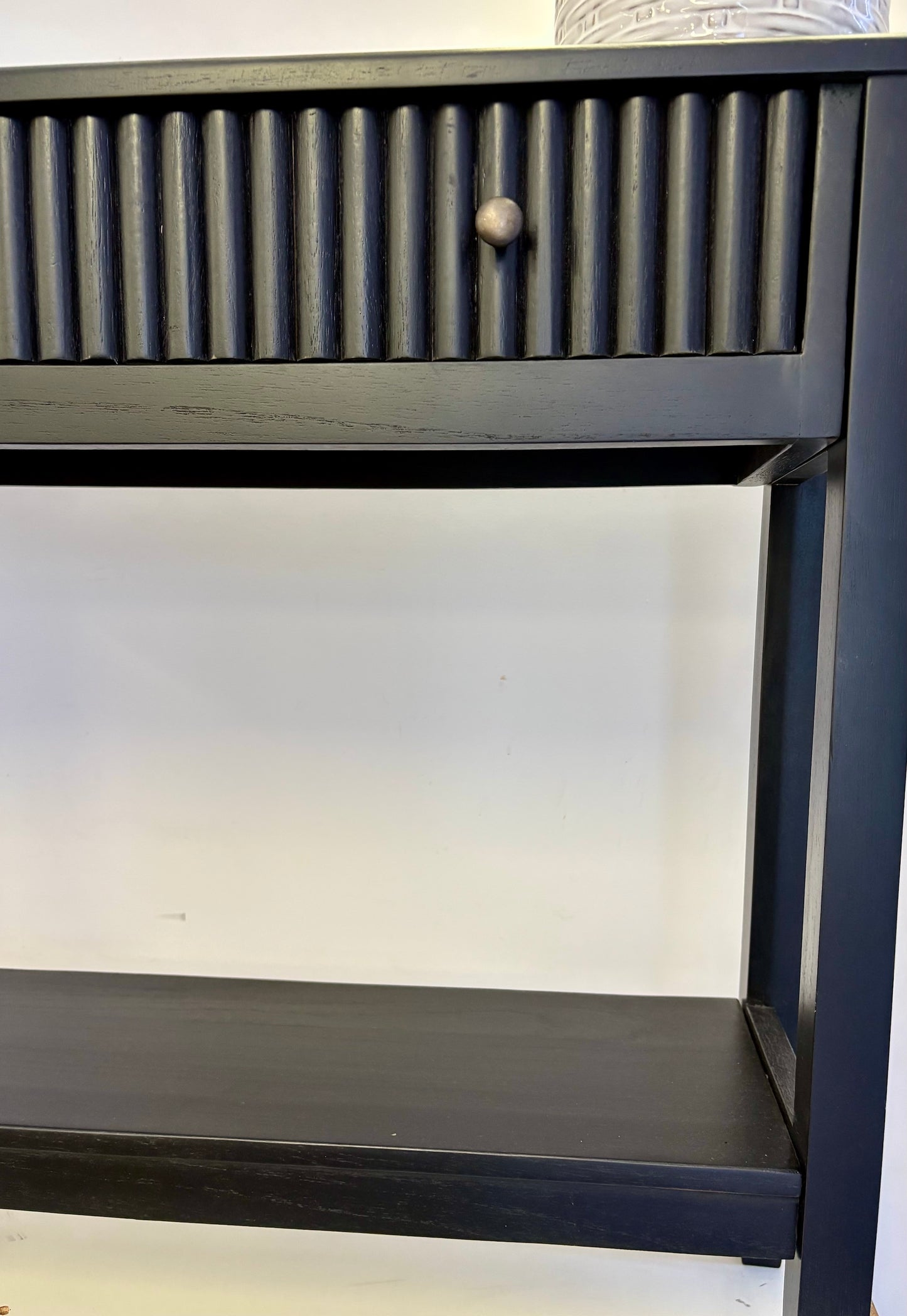 The Vienna - 1 Drawer Black Console brings a contemporary feel with its sleek design and textured drawer face. Built with sustainable white cedar its 1-drawer sits on wooden runners. Colour black. Measures 800 length X 250 depth X 750 height. End.