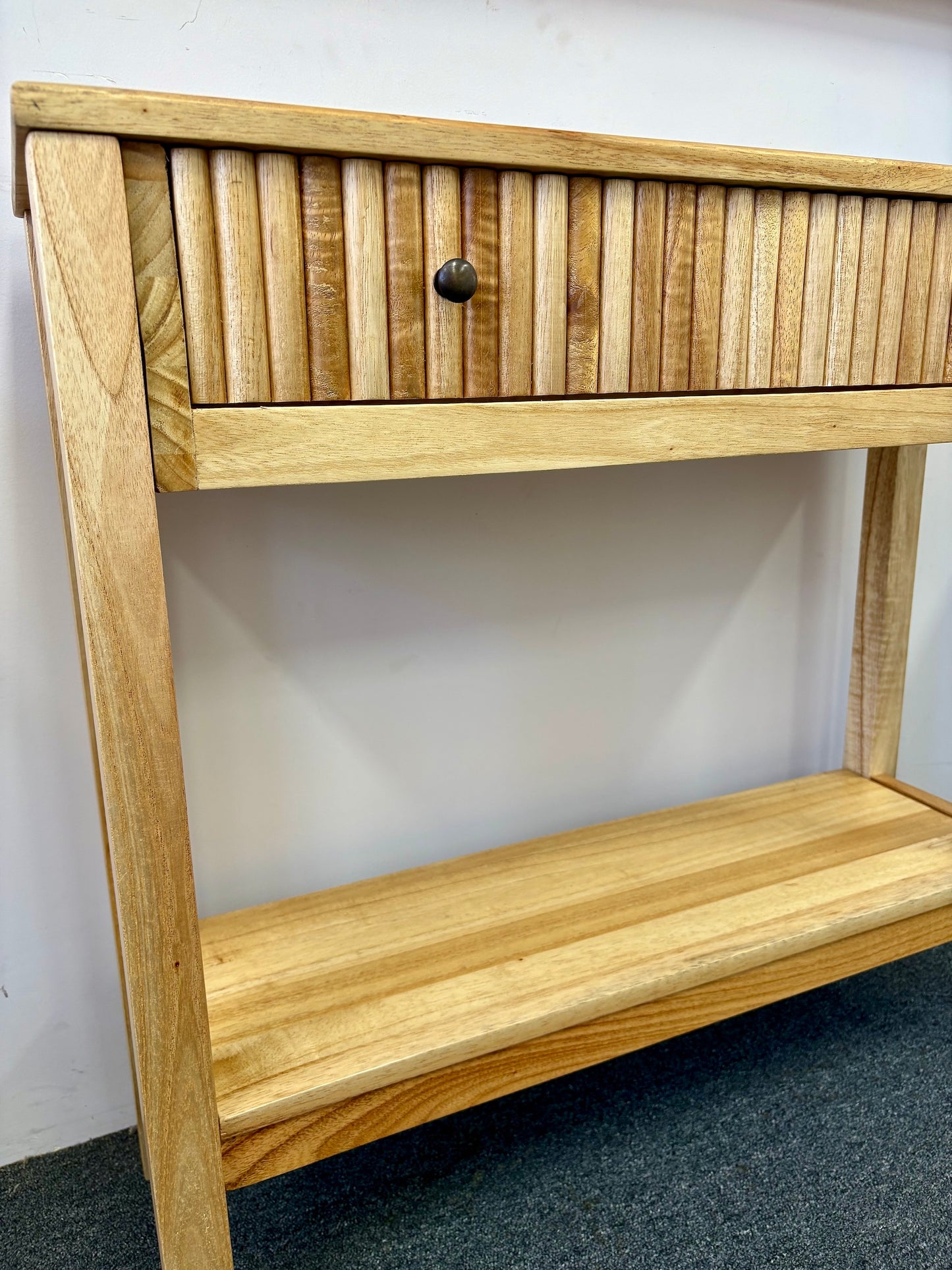 The Vienna - 1 Drawer Natural Console, natural, brings a contemporary feel with its sleek design and textured drawer face. Built with sustainable white cedar its 1-drawer sits on wooden runners. Colour natural. Measures 800 length X 250 depth X 750 height. Angle.