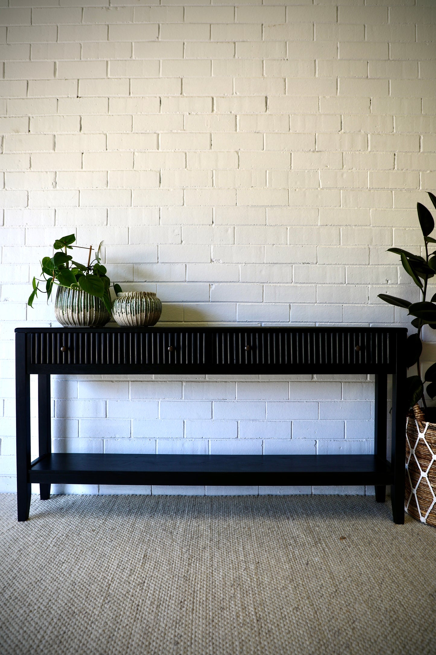 The Vienna - 2 Drawer Black 1500 Console brings a contemporary feel with its sleek design and textured drawer face. Built with sustainable white cedar its 2 drawers sit on wooden runners. Colour black. Measures 1500 length X 250 depth X 750 height. Styled.